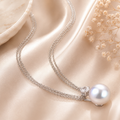 Amour  11-12mm Cultured Freshwater Pearl and 5/8 CT TGW White Topaz Pendant with Chain In Sterling Silver